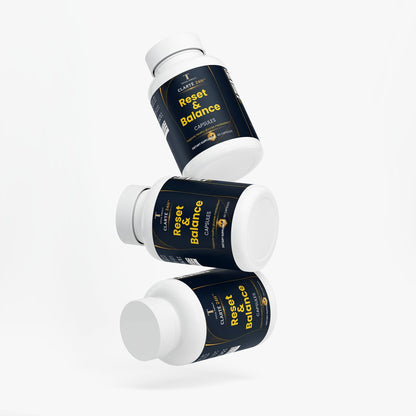 Berberine supplement in white plastic bottles with navy labels, gold accents, and bright yellow Reset & Balance lettering.